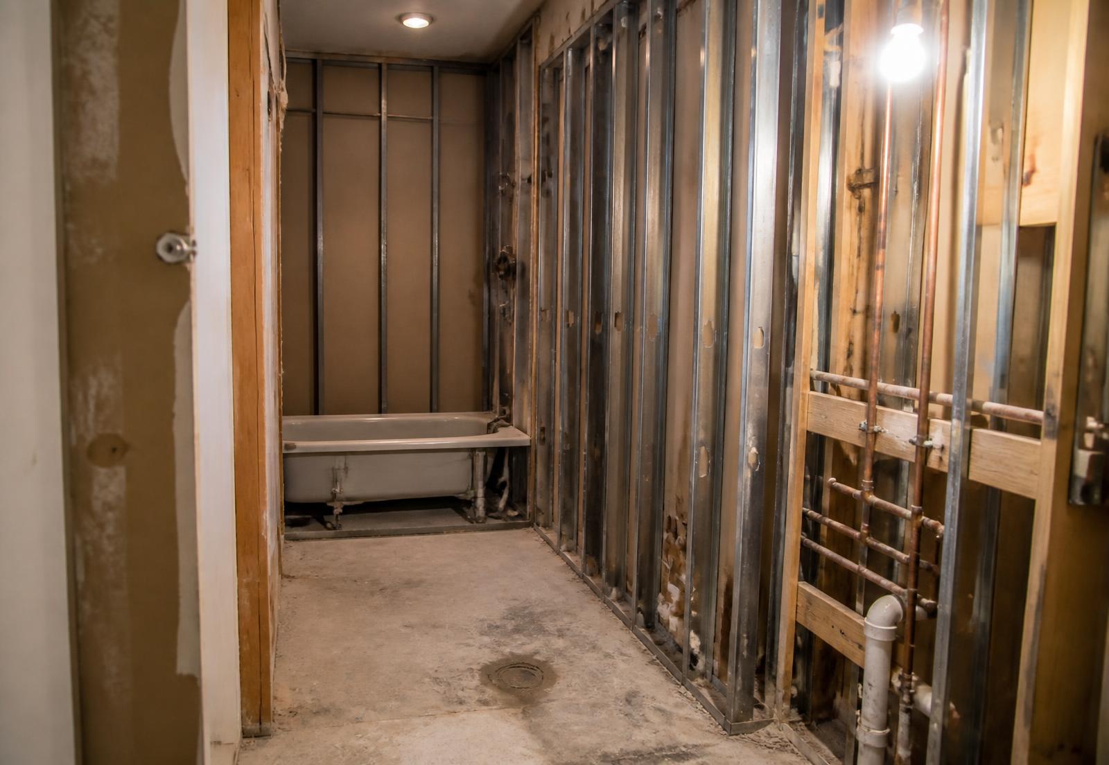 Hotel bathroom stripped to the studs before renovation
